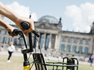 man riding a bike in front of the Reichstag
