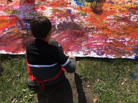 Junge malt am gemeinsamen Kunstwerk (Bild: Kulturcoaching gUG )