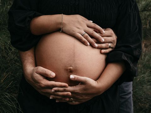 Hände um schwangeren Bauch