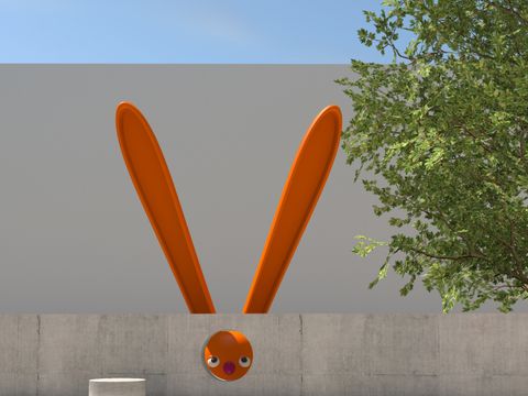 Graue Mauer mit comic-hafter, überdimensionaler Skulptur eines orangefarbenen Hasen