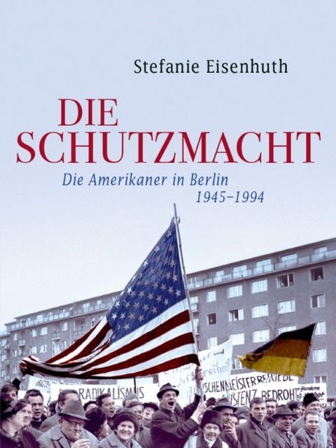 Bildvergrößerung: Cover des Buches "Die Schutzmacht", das eine Menschenansammlung zeigt, die hinter einer Absperrung steht. Die Menschen halten Plakate sowie eine deutsche und eine amerikanische Fahne in die Luft.