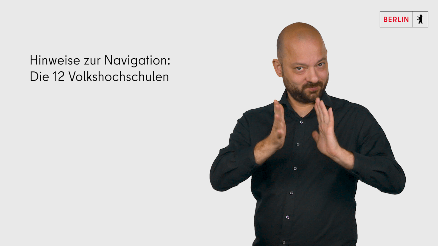 ein Gebärdendolmetschern erklärt in Deutscher Gebärdensprache die Navigation des Webauftrittes der 12 Berliner vhs 