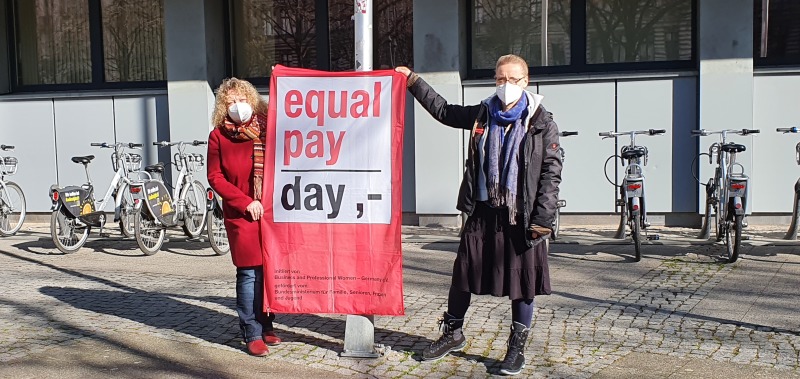 Romana Wittmer und Petra Koch-Knöbel hissen die Equal Pay Fahne.