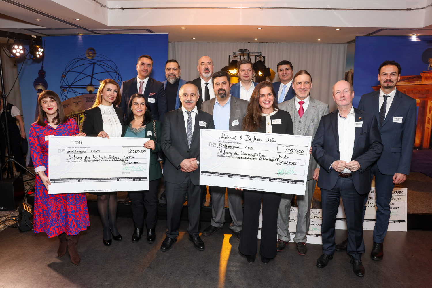 Neujahrsempfang 2025 - v.l. vorne: Elif Weiland (TDU), Esma Tekin (TDU), Saziye Kaplan (TDU), Remzi Kaplan (TDU), Mehmet Uslu (TDU), Yesmin Kelesoglu (TDU), Karsten Dietrich (WKHL), Rainer Wiebusch (Stiftung WKHL), Burhan Cetinkaya (Wirtschaftsförderung Lichtenberg), vl. Oben: Faith Demican (TDU), Florian Tanyildiz (OTA), Gürkan Öztas (TDU), Bezirksbürgermeister Martin Schaefer, Imam Hüseyin Peköz (TDU) bei der Checkübergabe. Insgesamt wurden 10.500 Euro gespendet. ©BA Lichtenberg/ Gerald Matzka