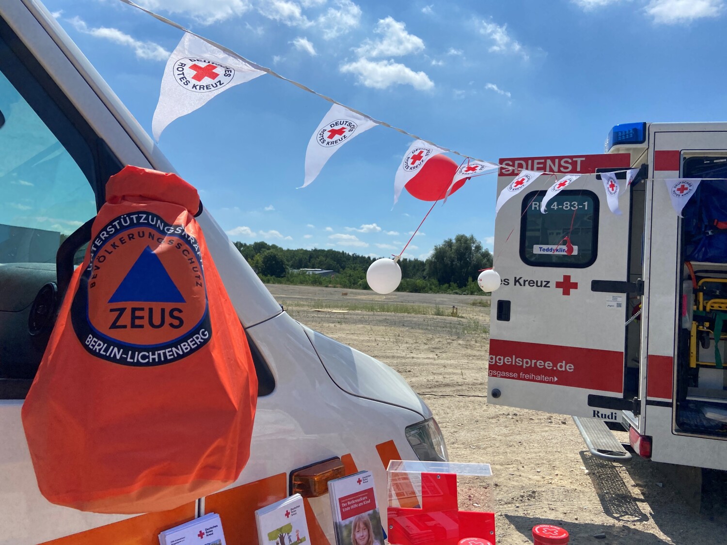 Symbolbild: Einsatzwagen des DRKs und Einsatztasche des ZEUS-Projekts
