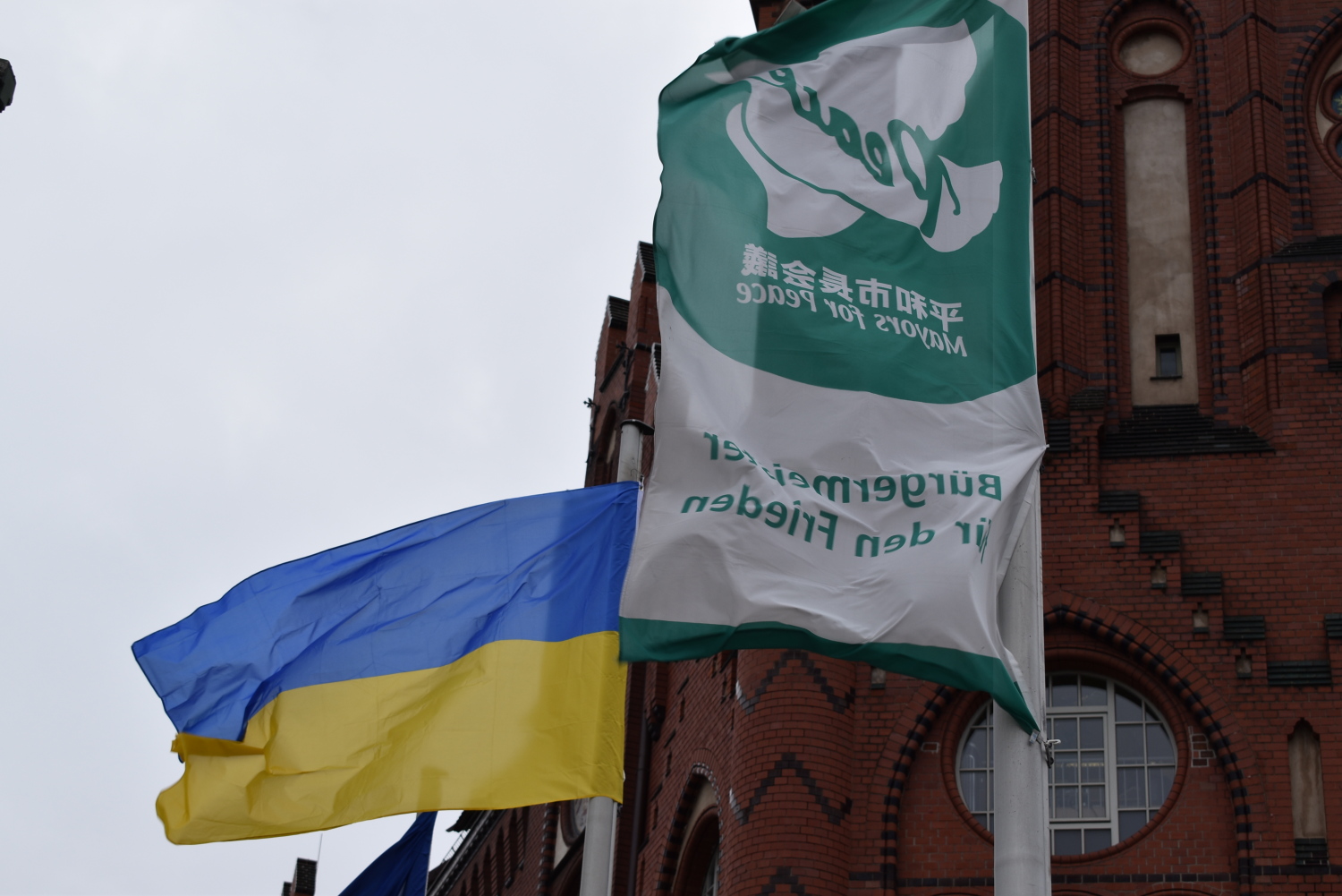 Ukrainische Flagge und Majors-for-Peace-Flagge vor dem Lichtenberger Rathaus