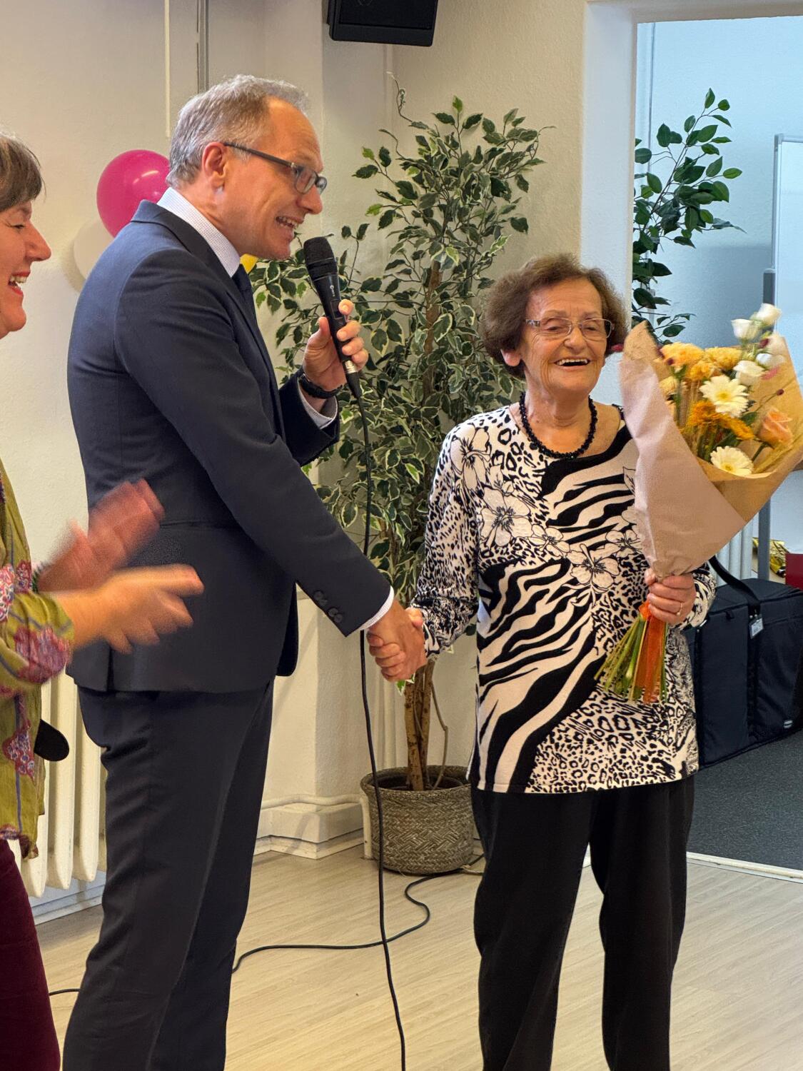 Frau Lask erhält Blumenstrauß und Danksagung von Bezirksstadtrat Spallek