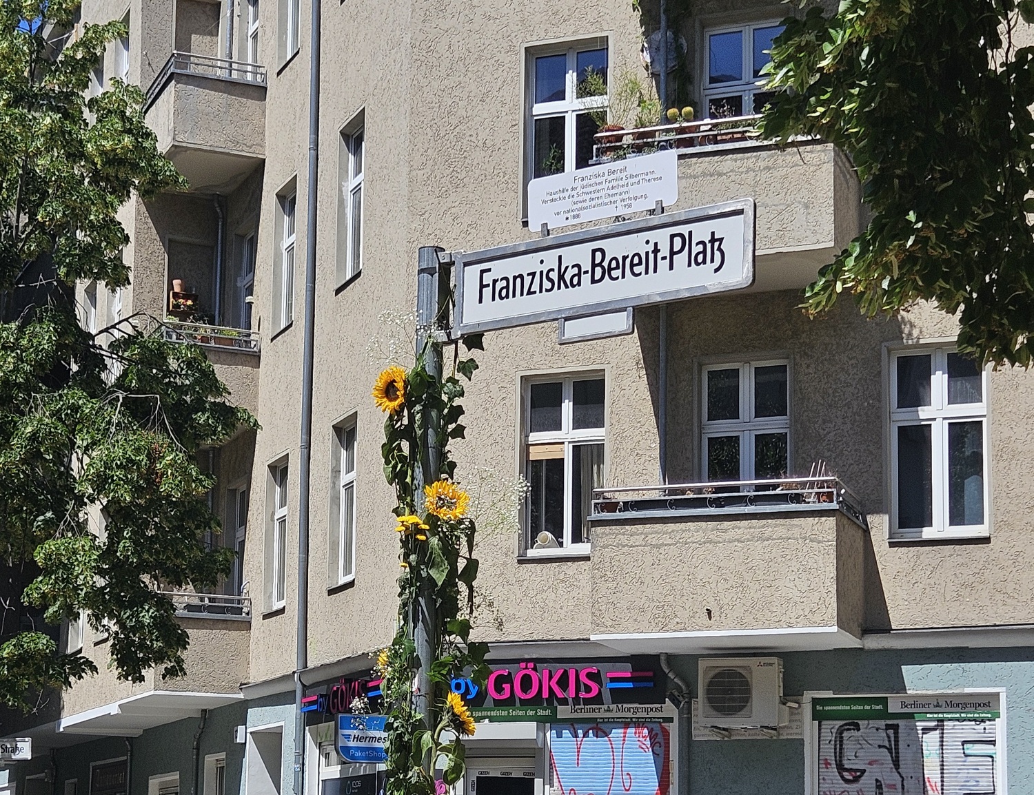 Straßenschild Franziska-Bereit-Platz mit Blumendeko