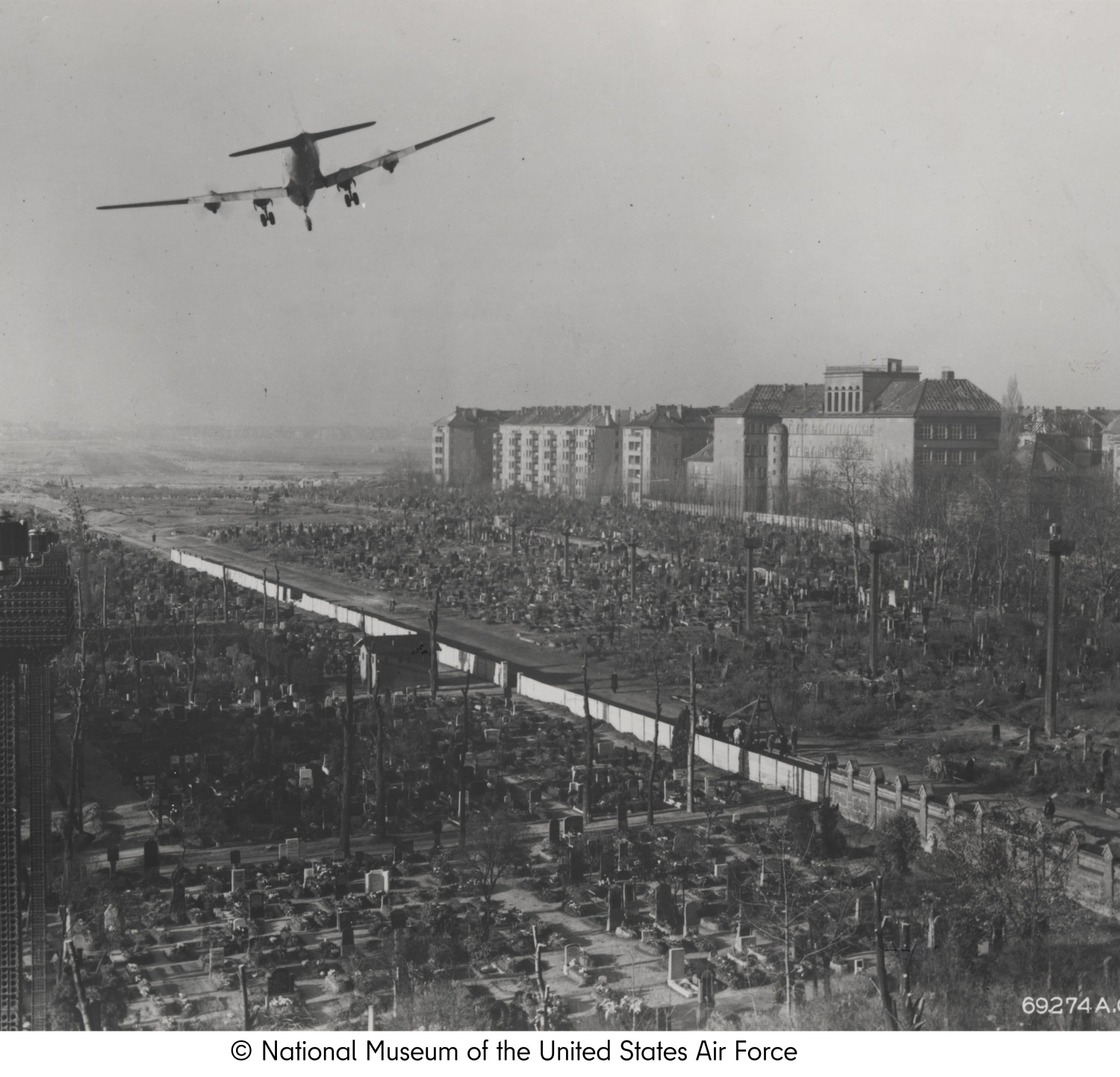 An airplane above a crowd