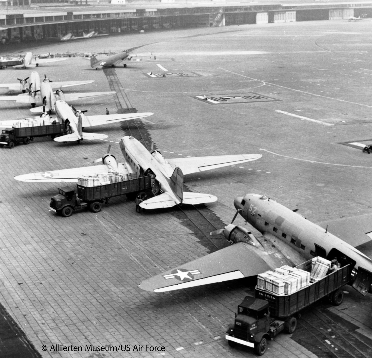 several airplanes on the landing field of an airport