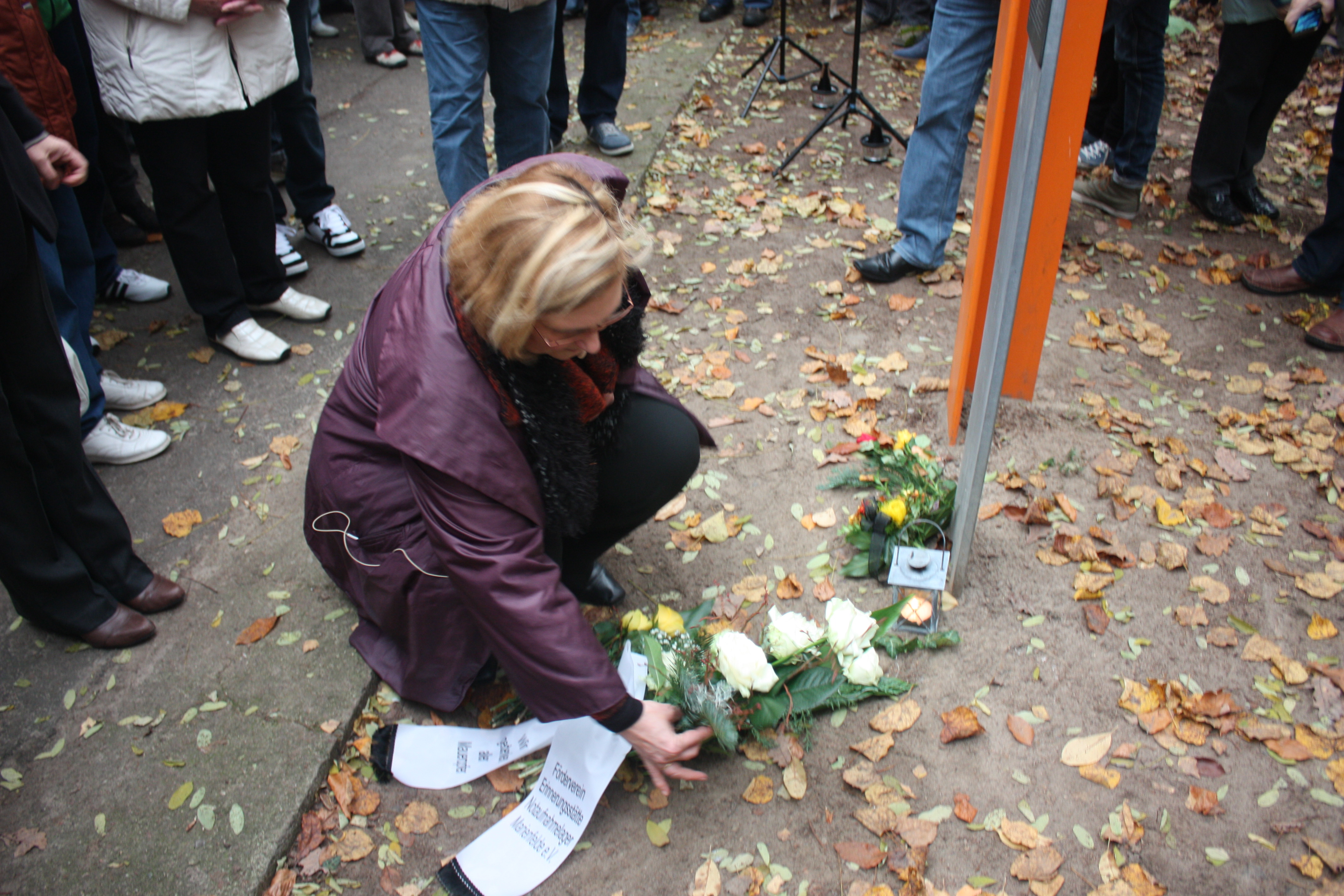 Angelika Schöttler legt an der Gedenkstele für Herbert Kiebler Blumen nieder