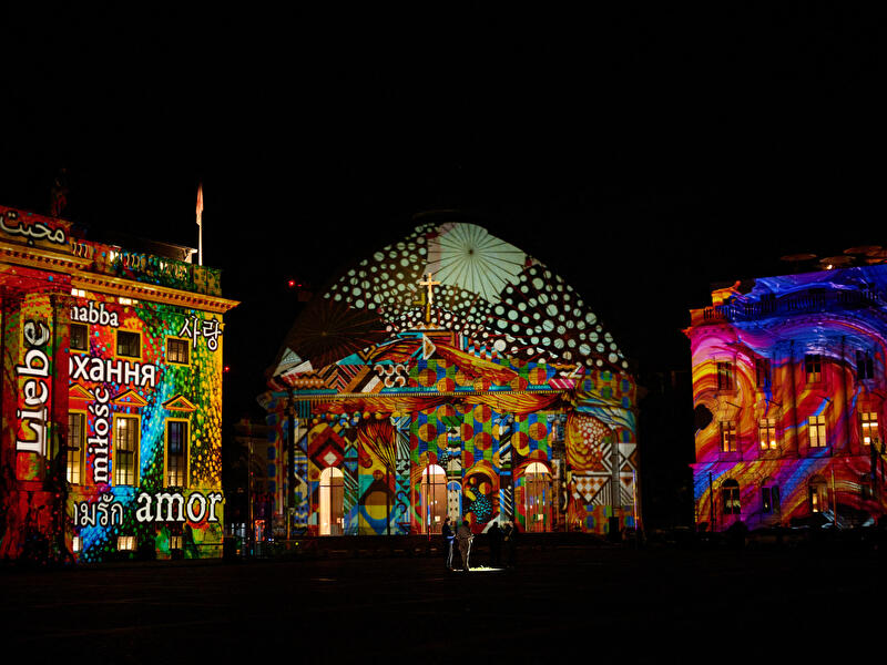 Bunt illuminierte Fassaden am Bebelplatz während einer Lichtprojektion.