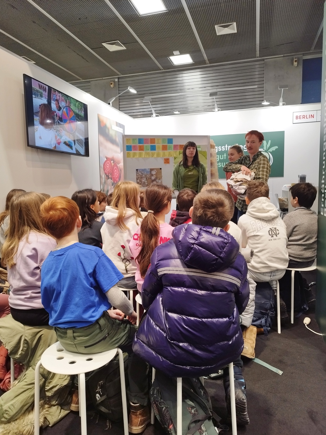 mehrere Schüler sitzen zusammen und folgen einem Vortrag bei einem Workshop