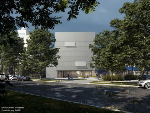 Ein futuritisch aussehendes graues Bauwerk in der Dämmerung