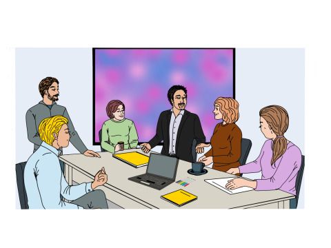 6 Personen sitzen an einem Tisch