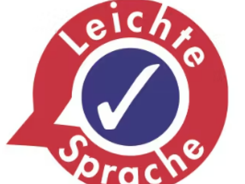Kreisrundes Symbol mit Haken und Schriftzug Leichte Sprache