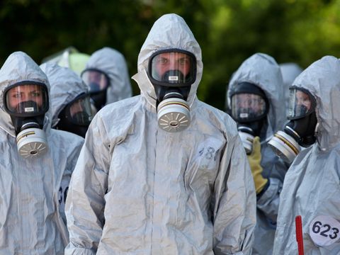 Männer und Frauen in CBRN-Schutzanzügen