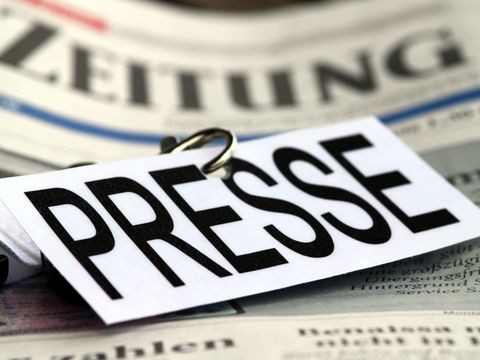 Ein Schild mit der Aufschrift "Presse" liegt auf einer Tageszeitung