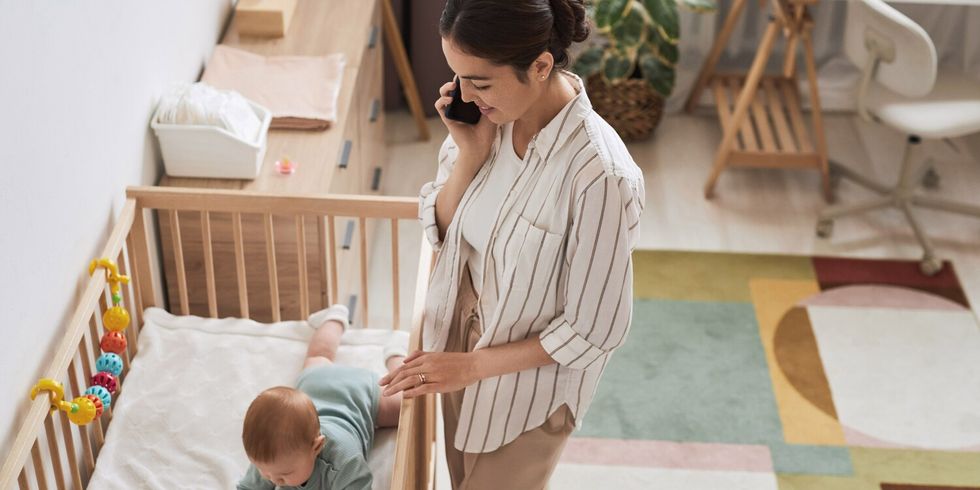 Smiling Young Mother Speaking on Phone