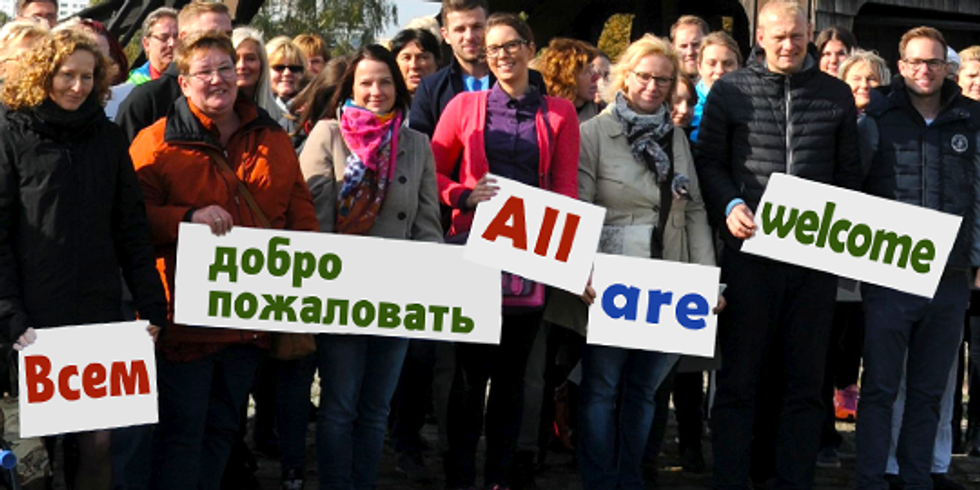 Personen halten Schild mit Schriftzug