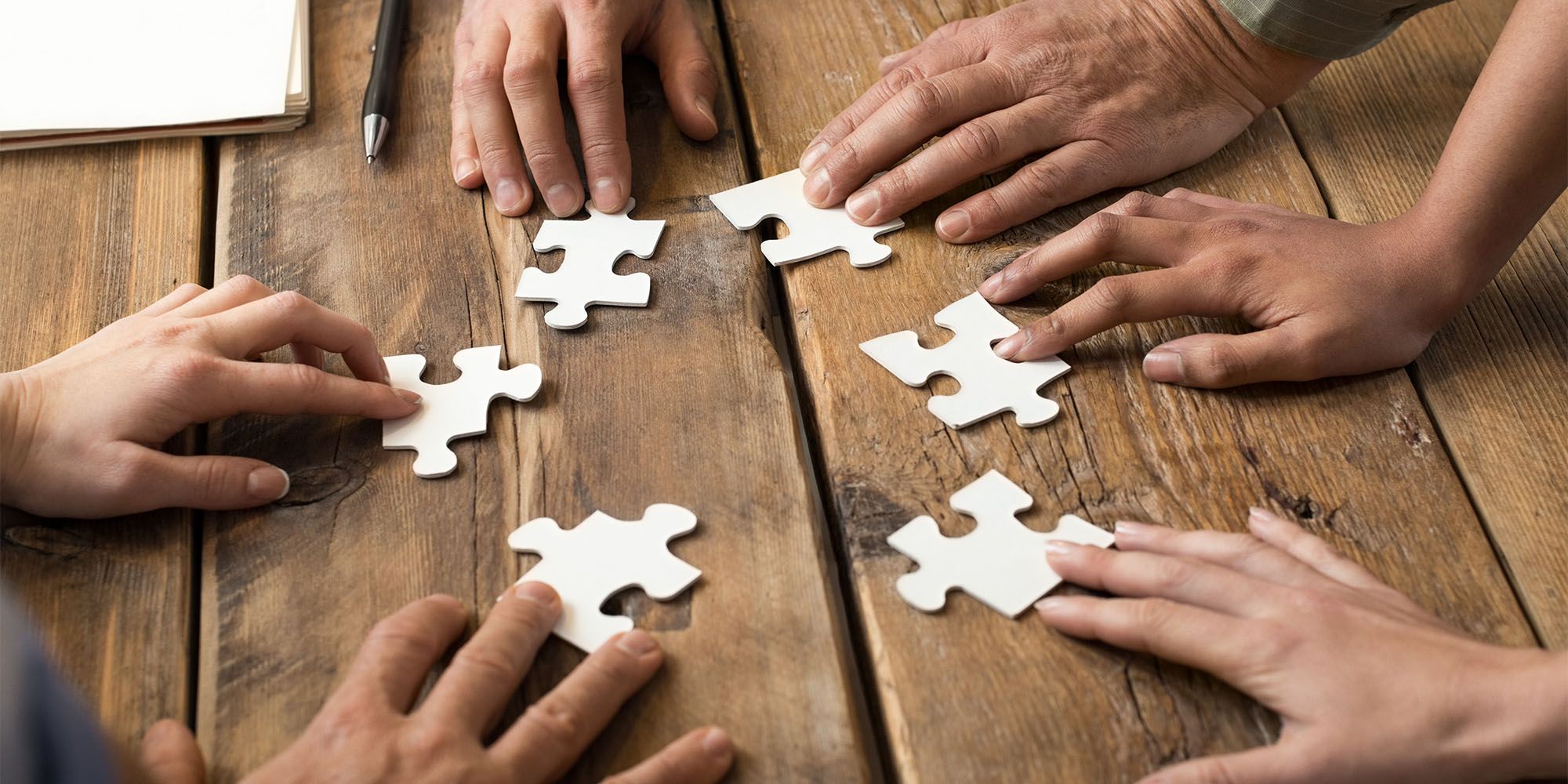 Hände Puzzelteile Tisch