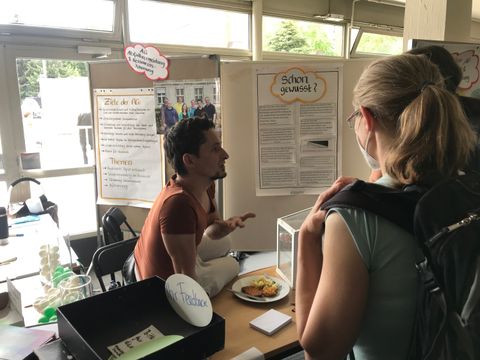Mitarbeitende im Gespräch am Stand der AG Ressourcenschonung und Abfallvermeidung