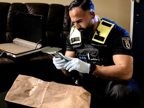 Polizist mit Handy in der Hand