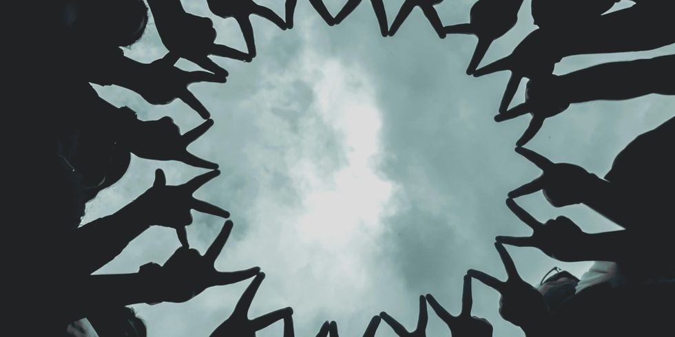 Silhouette von Menschenfingern unter düsterem Himmel / Silhouette of People's Fingers under Gloomy Sky