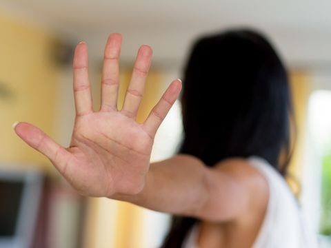 Frau mit ausgestreckter abwehrender Hand