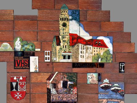 Emailearbeiten von Sehenswürdigkeiten in Neukölln auf roten Backsteinen, die die Umrisse des Bezirks zeigen. Hier im Ausschnitt nur der nördliche Teil des Bezirks mit dem Rathaus auf Emailiefliesen in der Mitte.