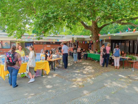 Menschen unterhalten sich an Marktständen