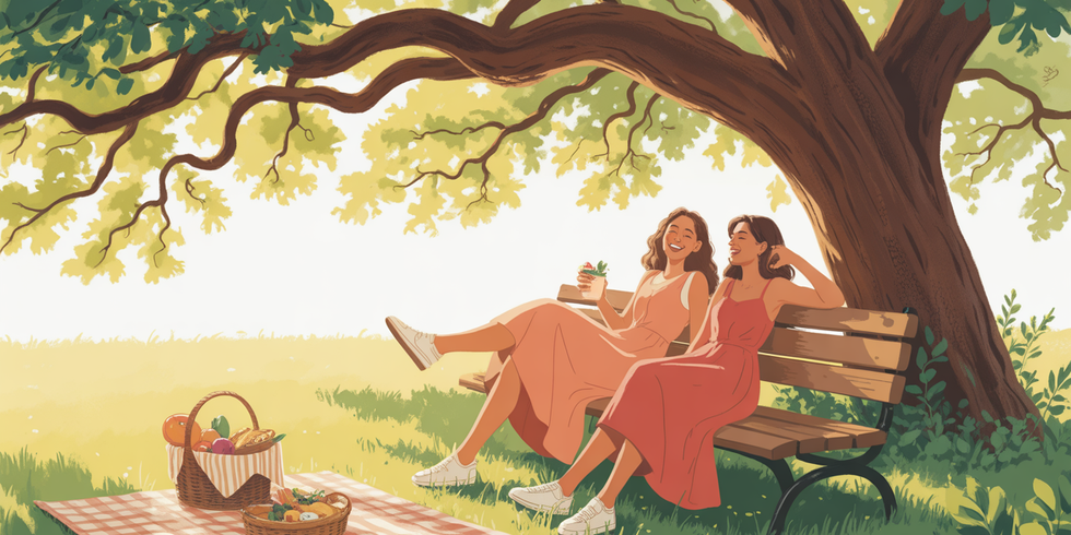 zwei Frauen machen ein Picknick im Schatten eines Baumes