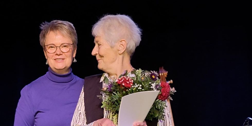 Die stellvertretende Bezirksbürgermeisterin und Sozialstadträtin Regine Sommer-Wetter (li) während der Ehrung auf der Bühne des Kleinen Theaters