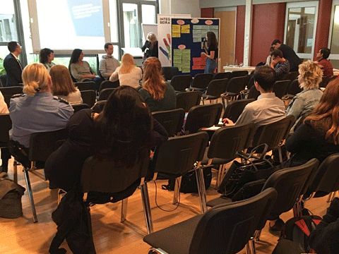 Menschen sitzen in einem Raum und hören zu