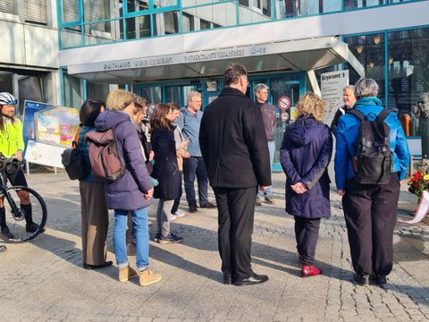 Die stellvertretende Bezirksbürgermeisterin Regine Sommer-Wetter und Andy Hehmke, Bezirksstadtrat für Schule, Sport und Facility Management, vor dem ehemaligen Rathaus Kreuzberg Blumen nieder