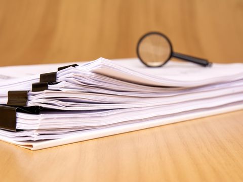 Organized Documents with a Magnifying Glass for Thorough Inspection and Review Processes