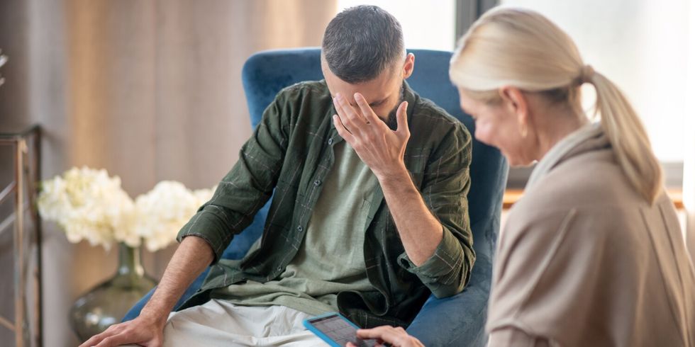Blonde-haired psychoanalyst helping a man with depression