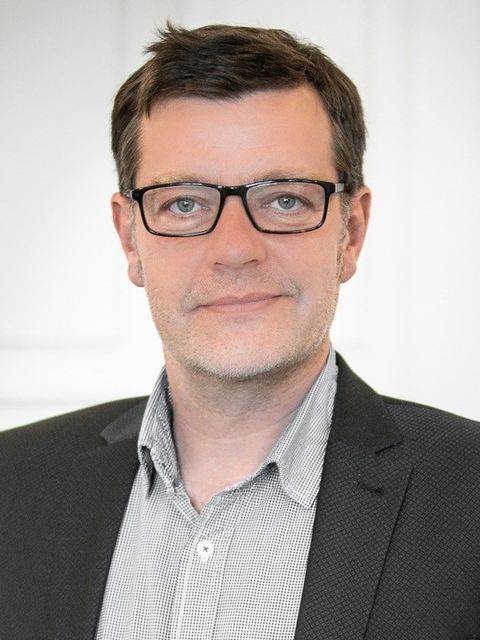 Mann lächelt in die Kamera