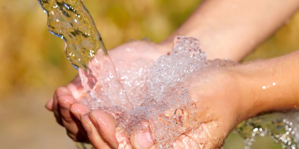 Hände werden unter einem Wasserstrahl gehalten