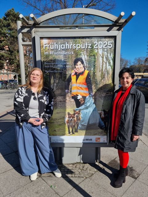 Bezirksbürgermeisterin Emine Demirbüken-Wegner (re.) und Harriet Vahldieck, Leiterin Team Städtemarketing & Public Affairs bei Wall, vor dem Plakat der diesjährigen Frühjahrsputz-Aktion an der Bushaltestelle vom Rathaus Reinickendorf. (Bild: BA Rdf)