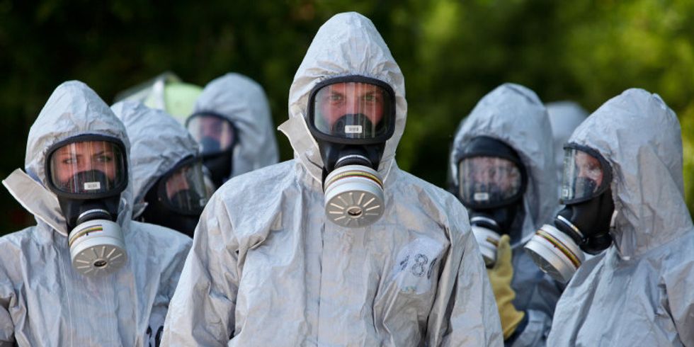 Männer und Frauen in CBRN-Schutzanzügen