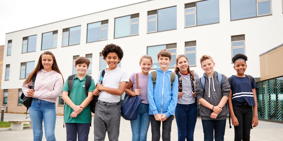Schüler und Schülerinnen vor der Schule
