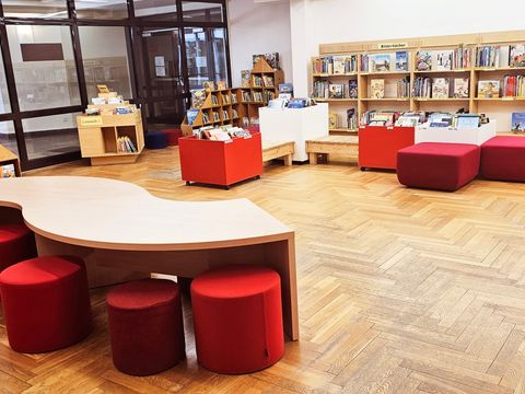 Kinderbibliothek mit Tischen und Hockern