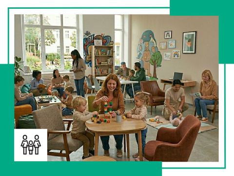 In einem Familienzentrum spielen Erwachsene und Kinder gemeinsam.