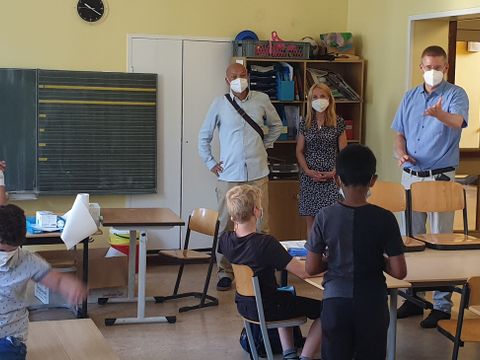 Bezirksstadtrat Tobias Dollase (r.) mit Nina und Olivier Rakotovao vom Träger Lieblingskinder gUG im Gespräch mit den Schülerinnen und Schülern. (Bild: BA Reinickendorf)