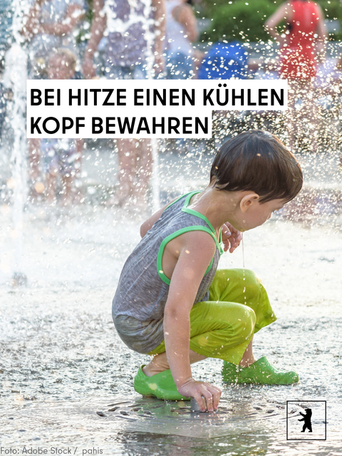 Ein Kind kühlt sich am Springbrunnen ab