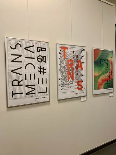Drei eingerahmte Bilder hängen an einer weißen Wand.