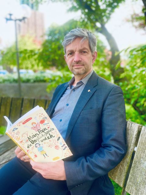 Bezirksstadtrat Oliver Schworck mit dem ersten Buch für Kinder aus suchtbelasteten Familien