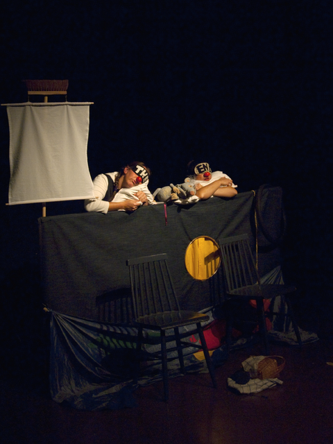 Fotografie einer Theaterszene und schlafenden Darstellenden