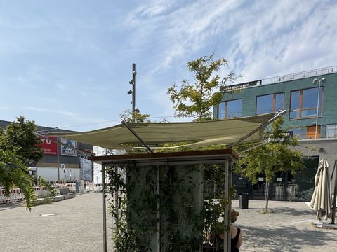 Zwei Sitzbänke mit einer begrünten Wand dazwischen und einem Sonnensegel darüber an der Yorckstraße
